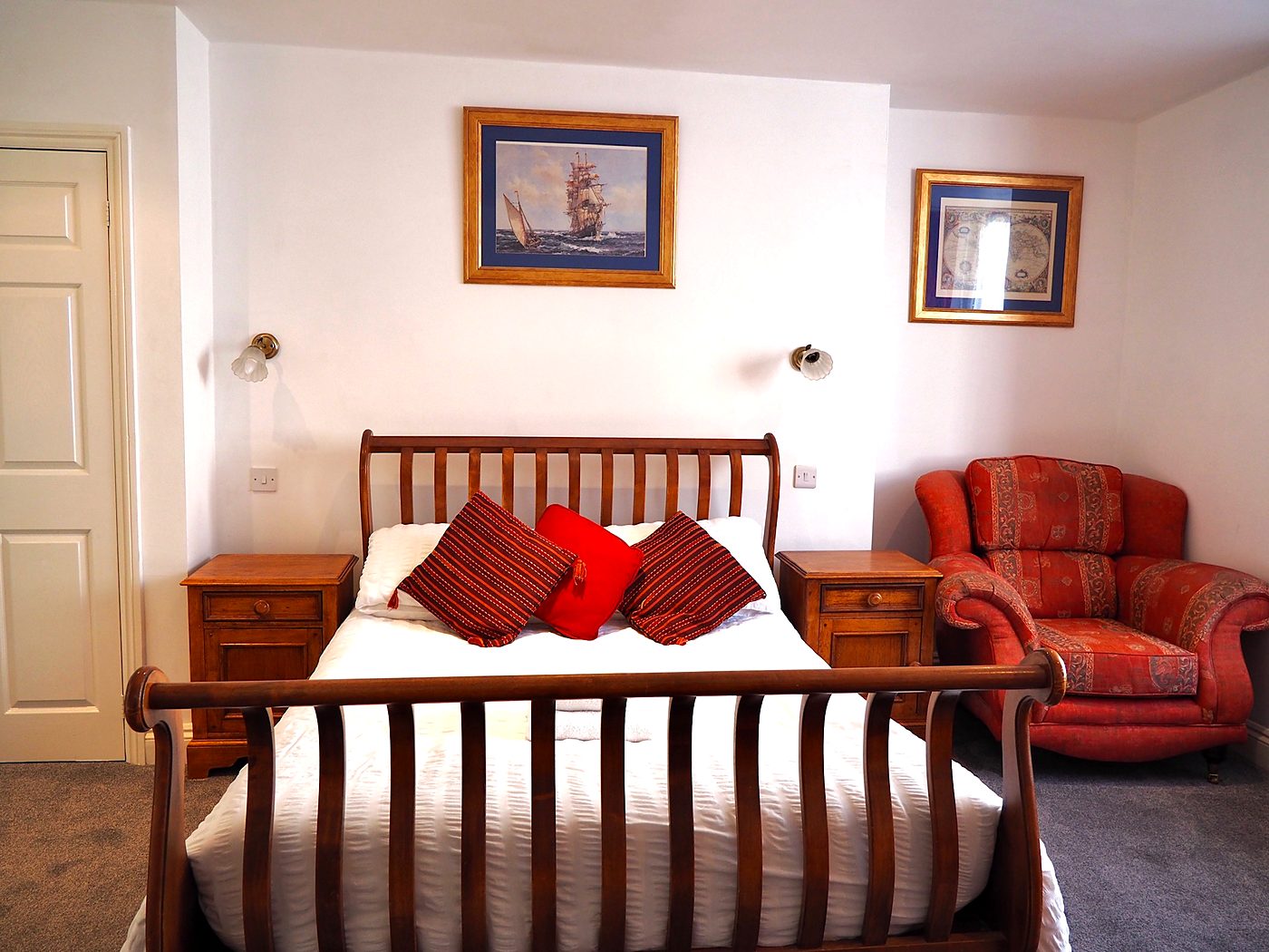 Double room with armchair and nautical prints at The Normandie