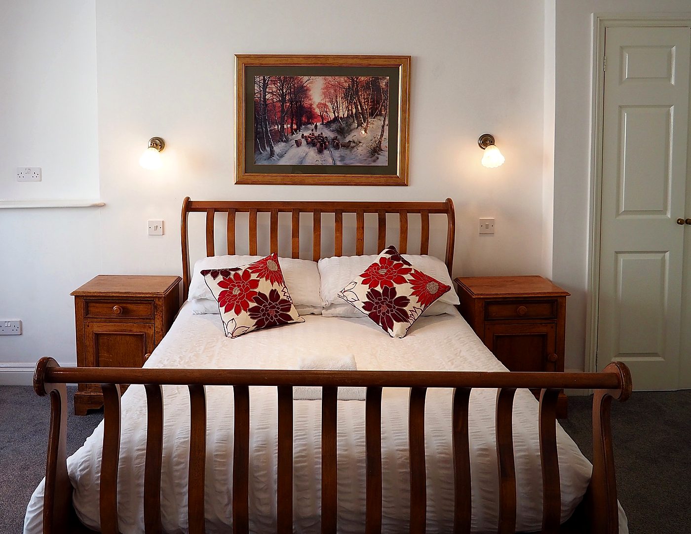 Double room with oak sleigh bed and reading lights at The Normandie, Tenby